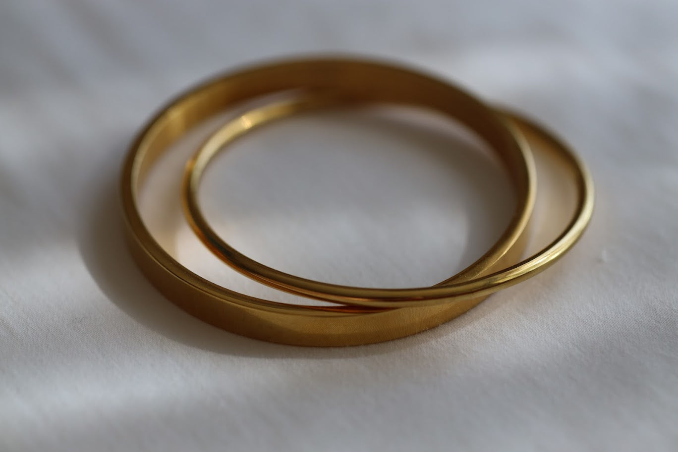 Marisol gold stainless steel bangle set with two stacked bangles.